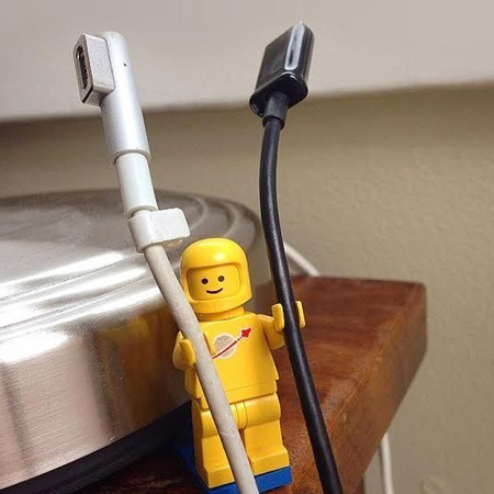 Corral clutter by using lego blocks and figures to hold cables and cords next to a desk