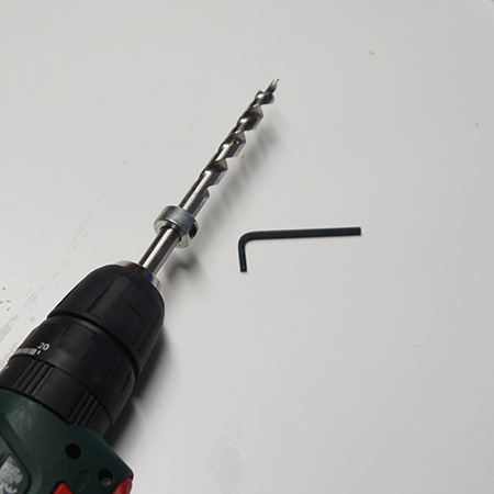 BELOW: To set the depth for drilling holes, use the guide and allen key the lock in place on the bit. 