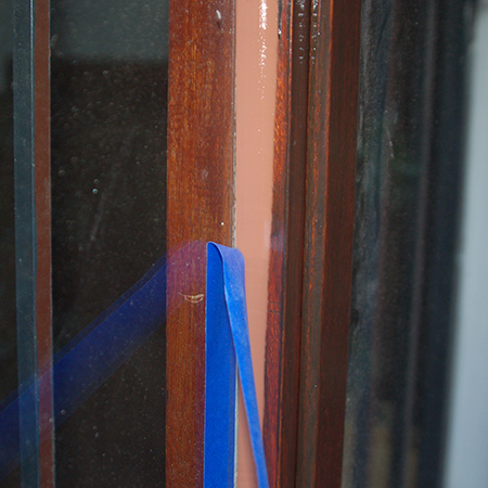 After applying the sealer, immediately pull away the masking tape and let the sealer cure.