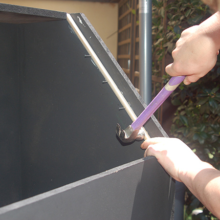 4. In this image you can see how the slots in the top allow for fitting the quarter-round rail down the sides. Attached with adhesive and panel pins. Both rails are cut at a 45-degree angle. 