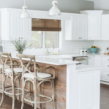 Reclaimed wood planks are mounted on a kitchen island