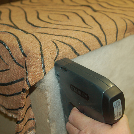 Upholstered ottoman staple fabric