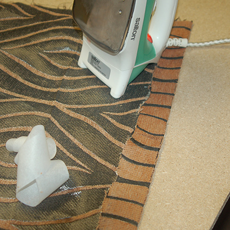 Upholstered ottoman iron seams