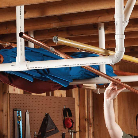 HOME-DZINE | Workshop Organisation - Long items aren't easy to store if they can't be stored upright. Where this is the case, use PVC plumbing pipes to make a hanging shelf mounted to wooden rafters to allow you to put these items out of the way. 