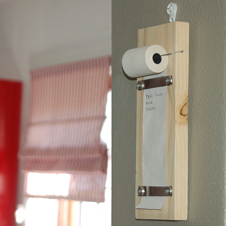 I normally have shopping lists all over the place and when it comes to buying what is needed something is always forgotten. I made this practical shopping list holder to hang on a wall in the kitchen using a few inexpensive supplies.