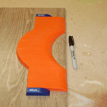 Once you have the shape, carefully lift the profile to transfer this onto the tile to be cut. 