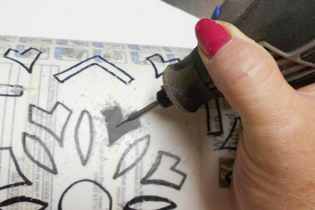 I like to use my Dremel MultiTool on recycling projects. You can use the accessories to cut out plastic [below], engrave on glass food jars, or even upcycle aluminium cans.