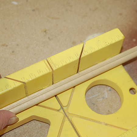 Measure and mark the moulding to fit around the outside of the base and cut this with a mitre box and backsaw