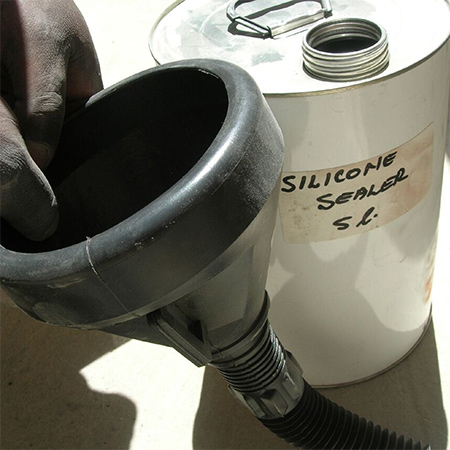 4. Using a funnel, pour SiliconSeal into the holes until it bleeds back through the face of the brick.