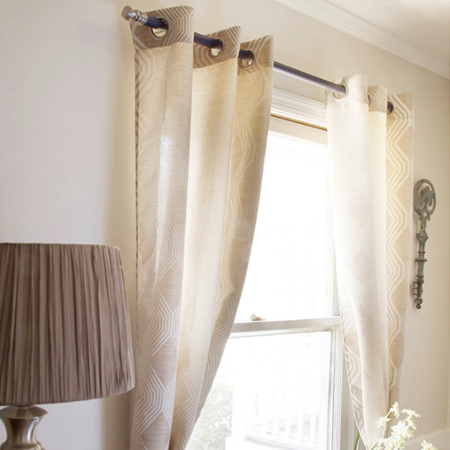 Using a pine dowel and your choice of knobs is an easy and affordable way to add a decorative curtain rail to your windows