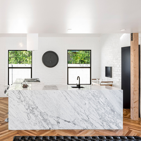 The renovation involved interior walls to be removed to increase light and space. The open plan living space on the lower level features a kitchen that takes centre stage