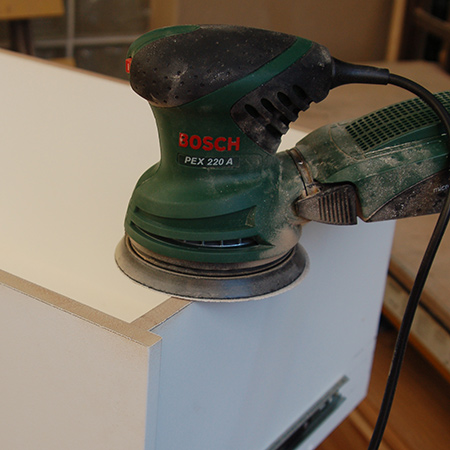 After removing excess with a planer, use 60- or 80-grit sanding pads to remove the material on top of joins. After that, you can sand the entire planed edge with 120- or 180-grit sandpaper. 