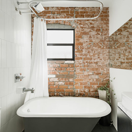 An exposed brick wall forms a wonderfully romantic backdrop