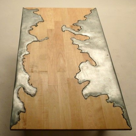 Pewter and wood flow together in this contemporary table that mimics the many design forms so popular right now