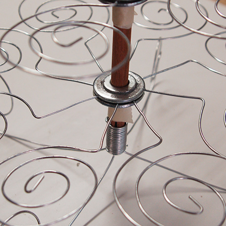 To secure the tiers onto the dowel rod, wrap a thick layer of masking tape around the dowel to mark the height of each tier.