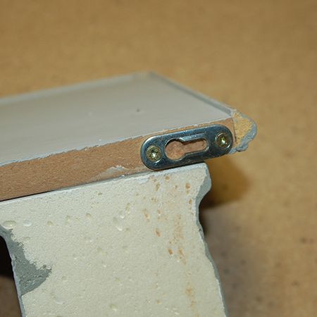 BELOW: Now you can see how the keyhole brackets are mounted on the back edge - each one facing in the same direction so that you can slip over screw heads and slide to the side to secure the shelf.