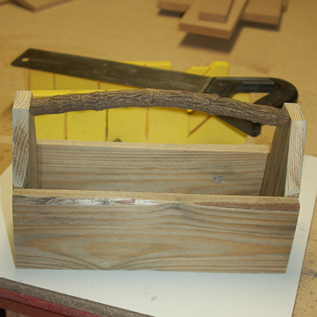I used a tree branch using a mitre box and saw to serve as a handle. Other alternatives include a pine dowel, or to use medium-gauge wire.