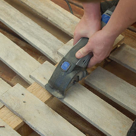 The easiest method for breaking down pallets is to use a Dremel DSM 20. This tool allows you to cut sections without having to remove steel staples or nails. 