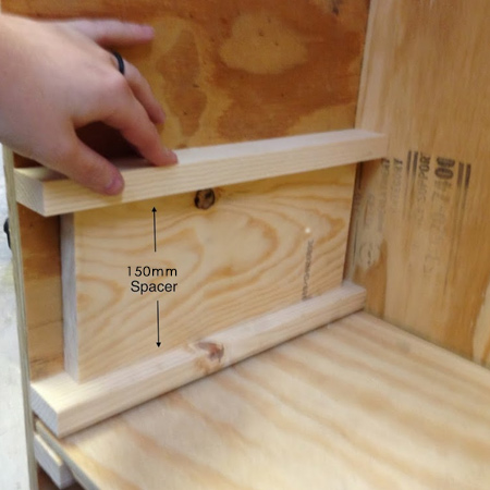 Within the frame are battens mounted to allow a slider shelf to fit between and move in and out of the cabinet