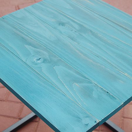 The steel frame table top finished with Rust-Oleum Chalked spray paint in Tidal Pond.&nbsp;