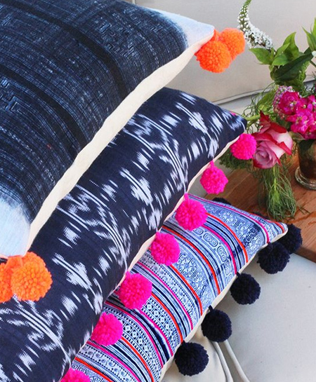 Pom-poms are an easy and affordable way to dress up plain cushions for a splash of colour and fun. Choose colours already used in a room to bring together a cohesive look.