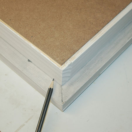 On the back of the frame, mark at 60mm up from the top and bottom edge.