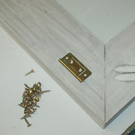 Use the drawn lines and mark to attach butt hinges to the frame back and cabinet / box frame front.