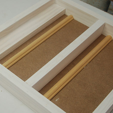 Cut moulding to fit inside the cabinet / box frame and glue in place.