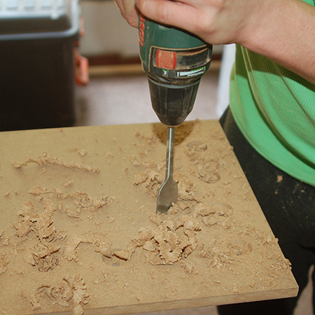 1.To ensure your laptop stays cool it's important to add ventilated holes. To do this you need a spade bit or hole saw and I used a 25mm spade bit.