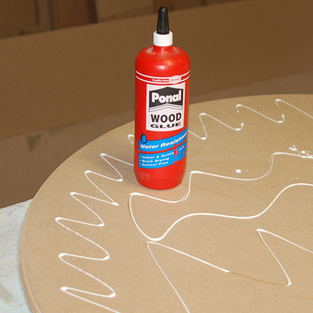 11. Apply wood glue to the larger, bottom piece.