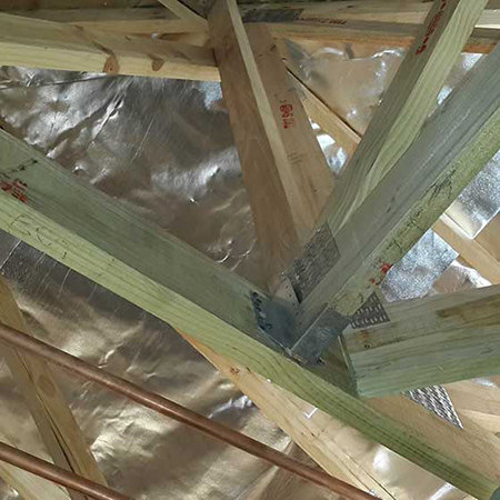 A 45-degree truss hanger not installed and a 90-degree hanger not completely nailed.