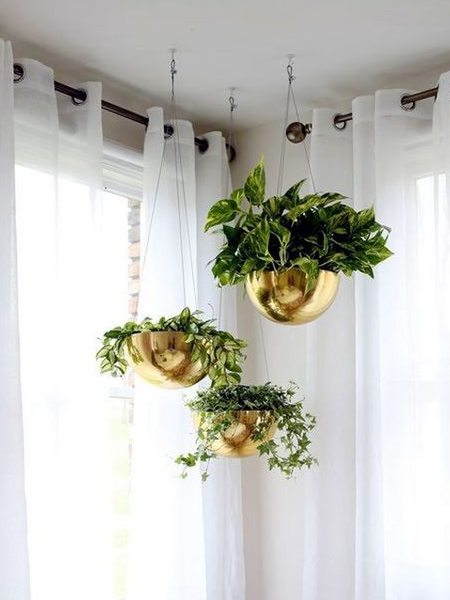 You wouldn't think that plastic bowls would make attractive plant holders, but give them a coat or two of Rust-Oleum Universal metallic spray paint and you have affordable planter hangers that look stunning.&nbsp;