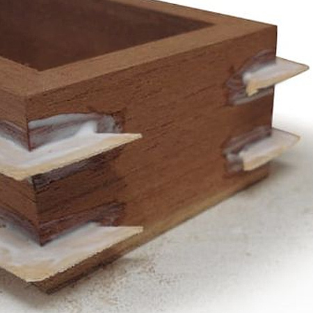 4. Squeeze wood glue directly into the slots and coat each side of the veneer. Slide the veneer key into place and leave to dry overnight. Use a sharp craft knife to cut away excess veneer. Any remaining veneer can be removed when sanding the finished project.