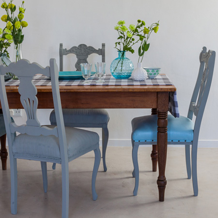 Chalk paint is an easy way to give faded fabric on dining chairs a quick refresh. It's easy to apply, dries quick, and is available in a wide range of muted colours.