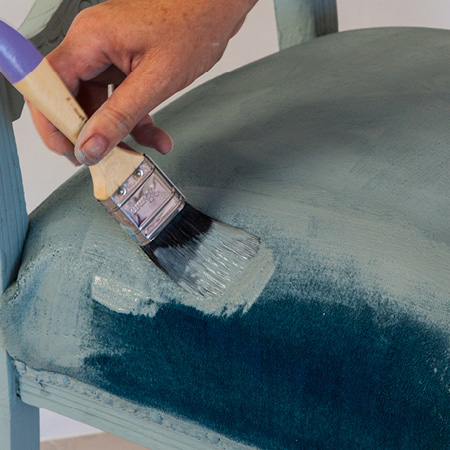 Use a quality paintbrush to apply chalk paint to the chair fabric. You will need to apply two coats for most fabrics, but some fabrics may need an additional coat. After applying two coats and letting dry, you should be able to determine whether additional coats are required.