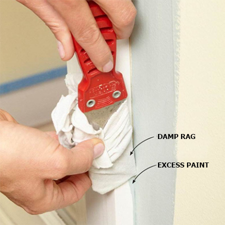 wrap a damp rag - one layer thick - around a putty knife and then carefully slide the putty knife along the excess paint to wipe it off