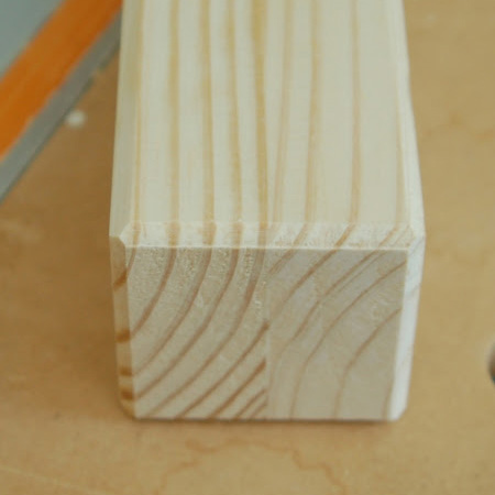 Set up your router or table router with a 'V' groove router bit. The 'V' groove router bit only removes a small amount of wood or board along the edge to give your legs, slats or work pieces a nice sharp finish.