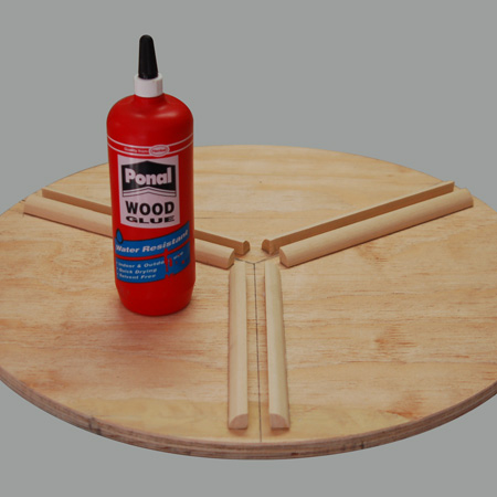 The quarter-rounds were glued to the table with Ponal wood glue. Press down hard and wipe away any excess glue that oozes out.