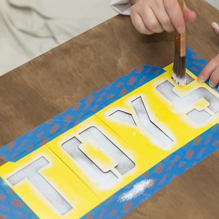 7. Let the sealer dry for the recommended time before taping down the stencils with masking tape. Use the centre guide as a mark for positioning the letter stencils.