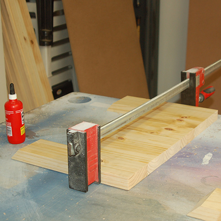 4. Laminate the side pieces with wood glue and bar clamps and leave these overnight. If you don't have bar clamps, wrap tightly with duct tape to hold the sections together.