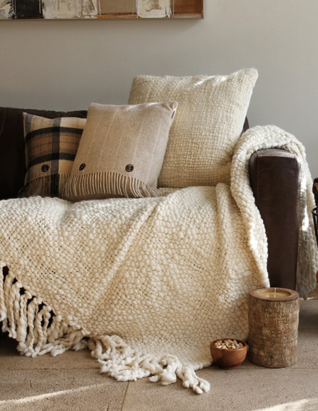 Create a warm, cosy interior with soft textures  – think chunky knit cushions, faux fur throws and woollen rugs. Layer different tactile elements to create a styled look and combine with a roaring fire or soft candlelight.
