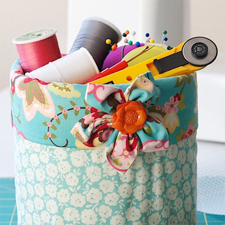 Recycle coffee canisters into colourful containers to organise tools in the sewing room, or use as a mini trash can for scraps and threads by your sewing machine. There are so many other uses for these containers: Use to cover the base of a plant, hold crayons for a kid’s room, or even in the kitchen for utensils like wooden spoons.