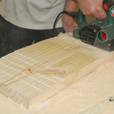 5. Repeat the planing on the underside of the seat. Start planing 100mm from the centre and work out to the sides to a total depth of 12mm at the edge. 