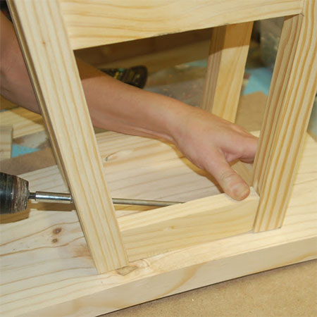 GOOD TO KNOW: The legs are secured to the seat and the final side sections screwed in place at the top.