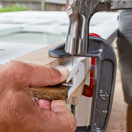 4. Clamp the piece in place and hold firmly with a clamp. If you need to add a few panel pins to hold the pieces together, predrill pilot holes to prevent splitting the timber.