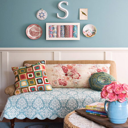 On one side of the sewing room is a small, comfortable settee