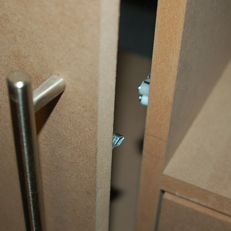 The rollers are mounted onto the cabinet frame - or a shelf - while the catch is mounted onto the door.