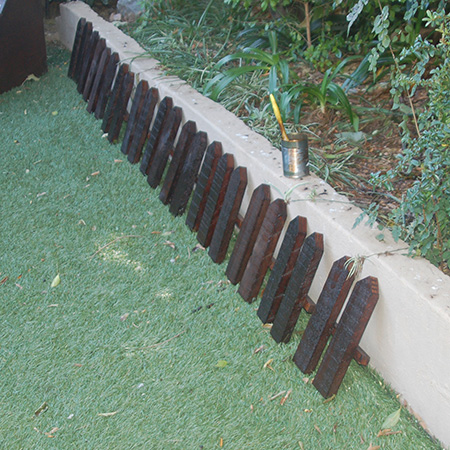 Two coats of Fired Earth Velvet Wood were applied to the fence sections.