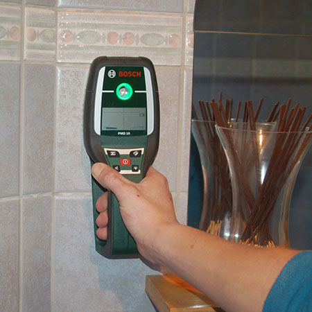 use detector to check before drilling into walls