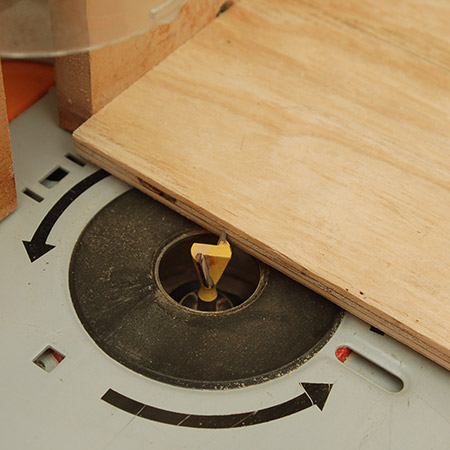 Cut out the slot with a dovetail bit. This depth is around three-quarters of the way through the plywood and this is the perfect height to hold a tablet or phone firmly in place.